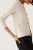 M&amp;S-kosc-sloniowa-sweter-kardigan-brazowy-guzik-modelka-przod.webp