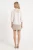 Primark-zamszowa-bezowa-spodniczka-mini-modelka-tyl.webp