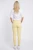 George-cytrynowe-spodnie-jeansy-zamki-modelka-tyl.webp
