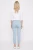 C&A-blekitne-spodnie-jeansy-crop-zamki-modelka-tyl.webp