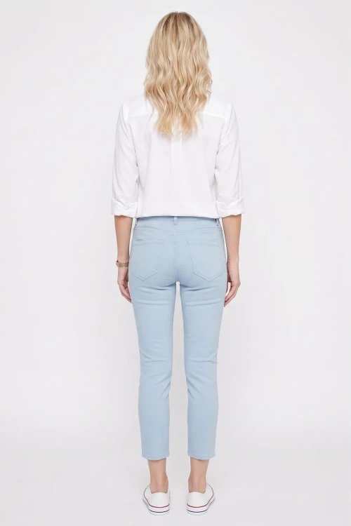 C&A-blekitne-spodnie-jeansy-crop-zamki-modelka-tyl.webp
